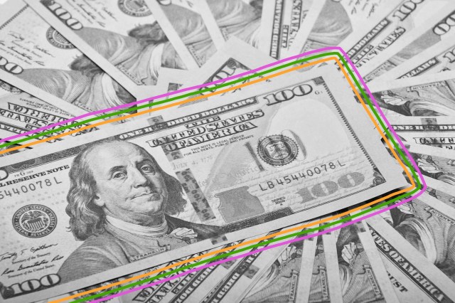 Pile of U.S. $100 bills featuring Benjamin Franklin