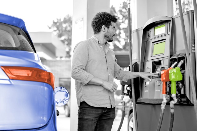 Man buying fuel at a gas pump