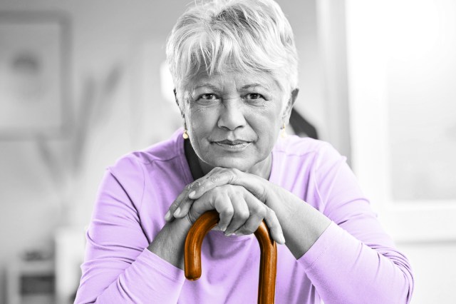 Older woman leaning on a cane